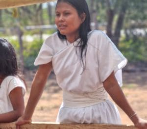 Photo d'une jeune fille qui fait sécher des fèves de cacao Ancestral en Colombie
